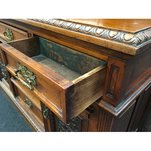 562 - A large Edwardian oak carved dresser with mirrored back.