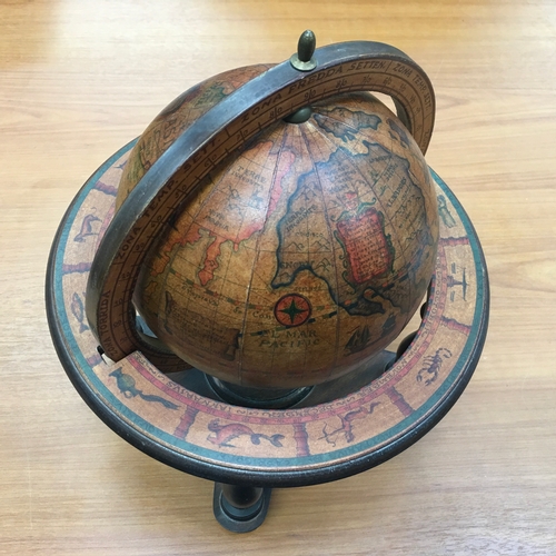 961 - A small wooden globe with signs of the zodiac.