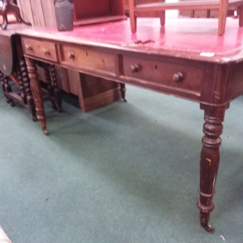 1443 - A mahogany partners desk with red leatherette inlay to top  resting on turned supports to castors.