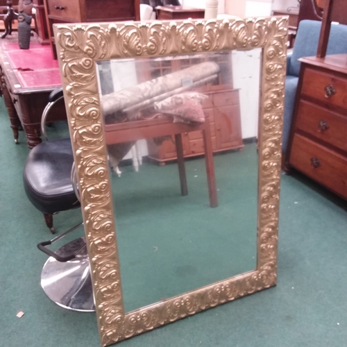 1445 - A gilt framed decorative bevelled edge mirror.