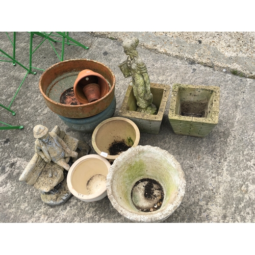 371 - A collection of concrete plant pots and statues.