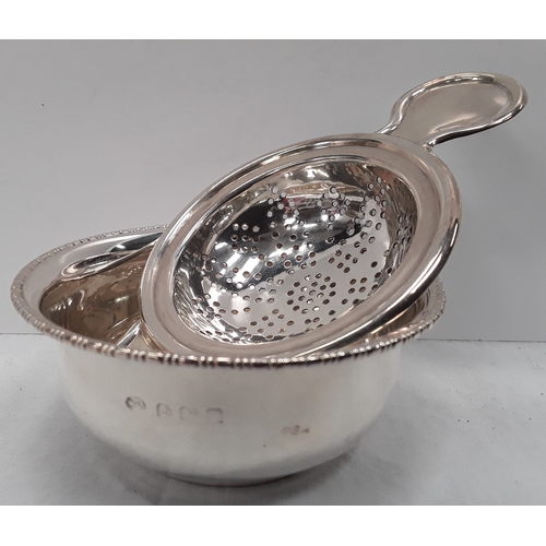 149 - Silver hallmarked tea strainer and bowl.