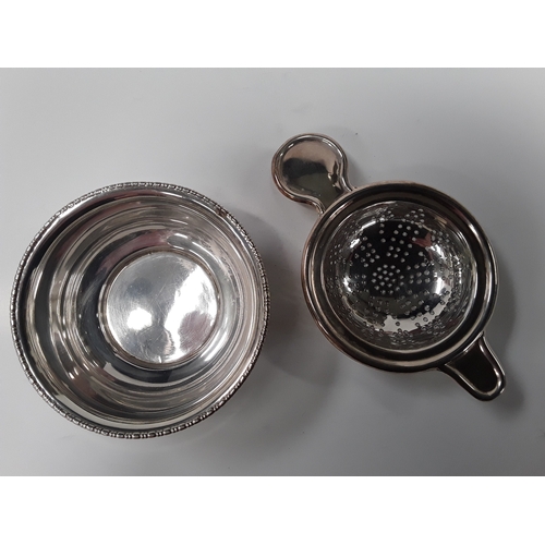 149 - Silver hallmarked tea strainer and bowl.