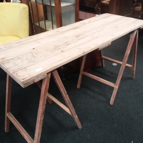 1551 - A plank topped trestle table.