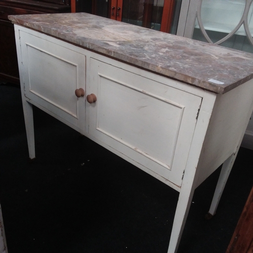 1536 - A marble topped washstand resting on stilt legs to castors.