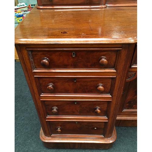 499 - A Victorian mahogany dressing table with twin banks of drawers and vanity cupboard, scrolled dressin... 