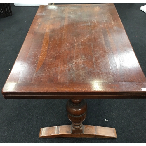 570 - A draw-leaf dining table in the refectory style on bulbous supports together with six high back dini... 