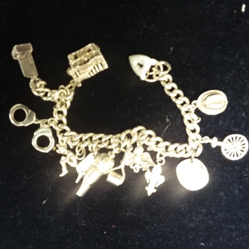 2149 - A silver charm bracelet and charms. (Ref.101.)