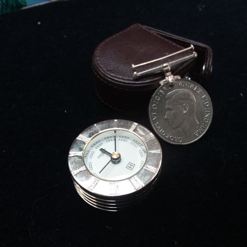 2152 - A travelling clock and a WWII defence medal. (Ref.225 & 310)