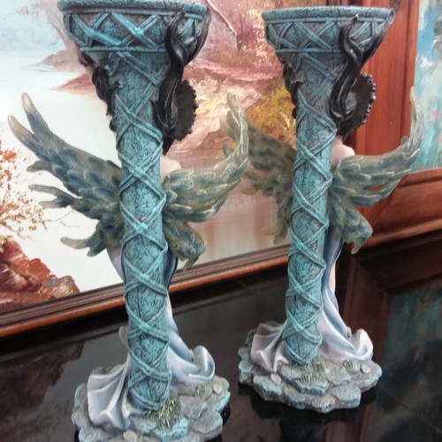 1016 - A pair of modern resin candlestick holders depicting mermaids.