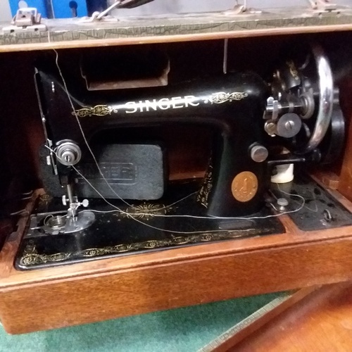 2046 - A Singer sewing machine with carry case.