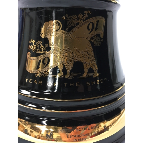 148 - A boxed Bell’s Fine Old Scotch Whisky Wade porcelain decanter 1991 “Year of the Sheep” (Chinese astr... 