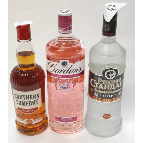 156 - Three bottles of alcohol: 1L Gordons Pink Gin, 1L Russian Standard Vodka and 70cl Southern Comfort (... 