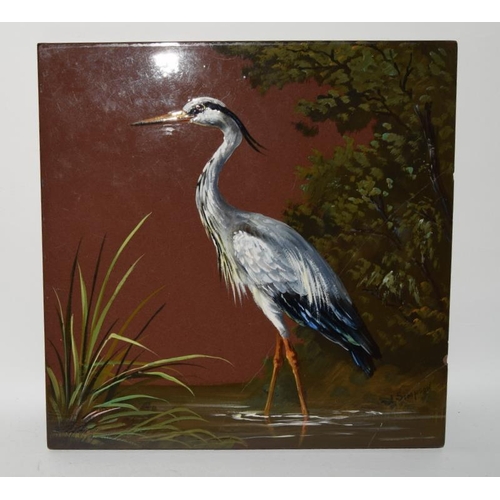 28 - Minton Hollins large handpainted slip clay tile depicting a stork (restored) together with one other... 
