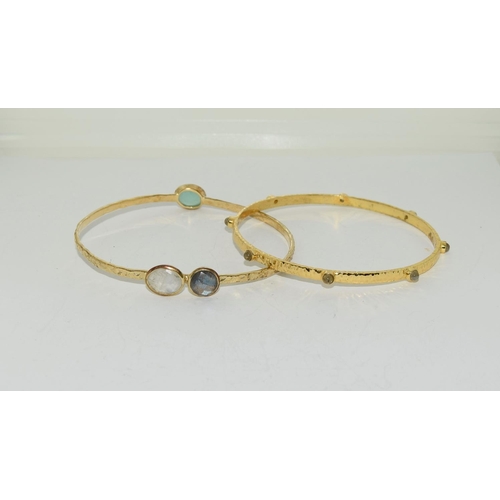 580 - Two moonstone and crysophase gilded bangles.