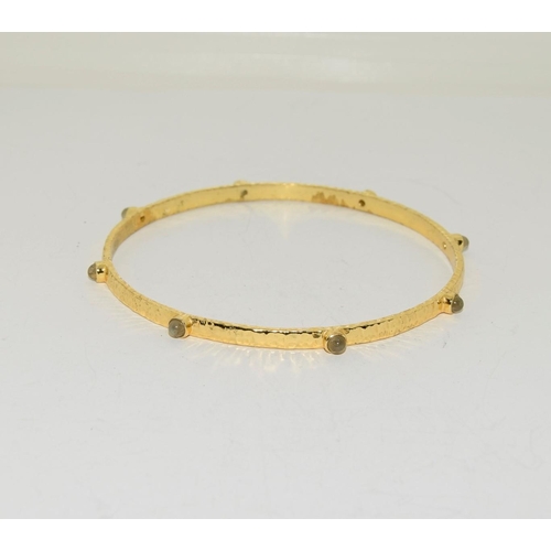 580 - Two moonstone and crysophase gilded bangles.