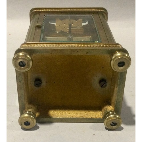 348 - Antique brass carriage clock with enamelled face and bevelled edged glass.