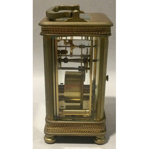 348 - Antique brass carriage clock with enamelled face and bevelled edged glass.