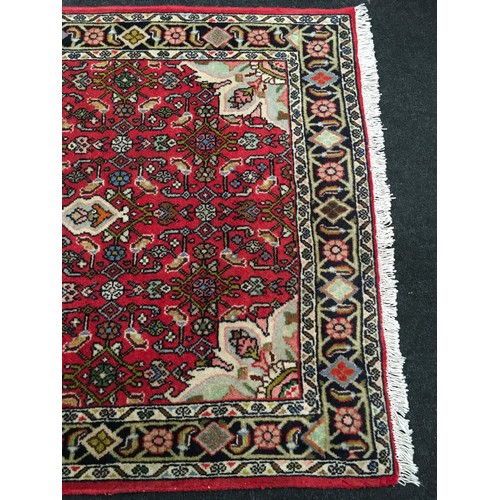 319 - Red Iranian rug in a red set pattern 130x70cm