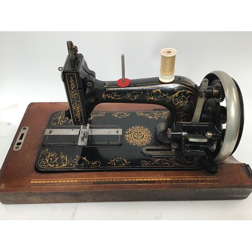 261 - Two vintage Singer sewing machines together with a vintage boxed G&C iron.