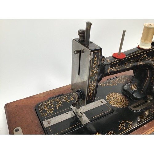 261 - Two vintage Singer sewing machines together with a vintage boxed G&C iron.