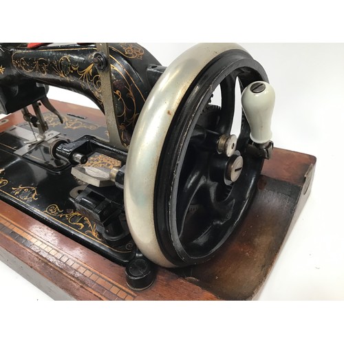 261 - Two vintage Singer sewing machines together with a vintage boxed G&C iron.