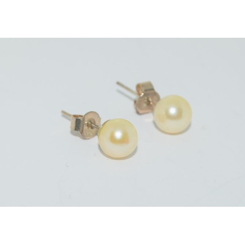 287 - A pair of pearl stud earrings on silver posts cased.