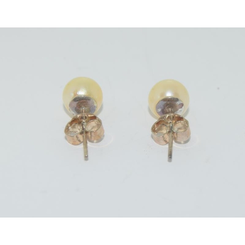 287 - A pair of pearl stud earrings on silver posts cased.