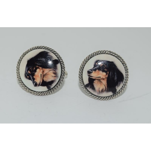 289 - A pair of silver and enamel cufflinks.