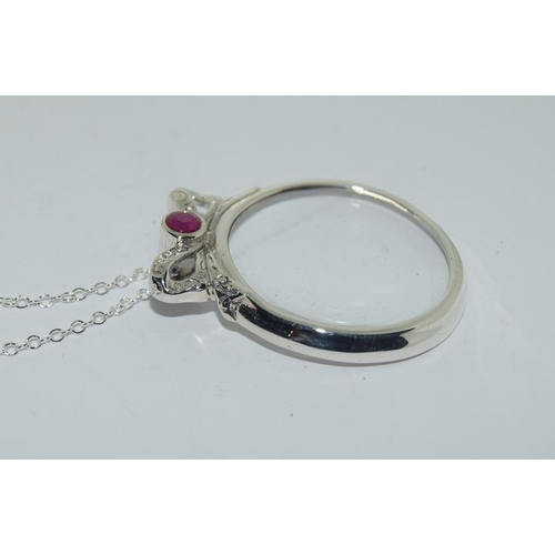 281 - A silver and ruby snake magnifying glass pendant necklace.