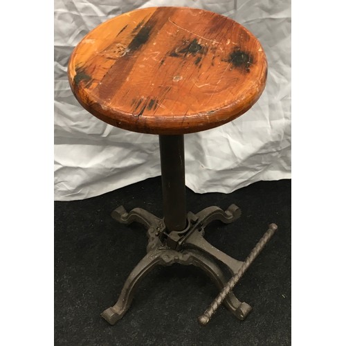 224 - Cast iron adjustable bar stool with wooden seat 60cm tall.