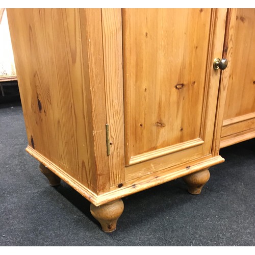 242 - Pine 3 draw over 3 door side board with brass handles and turned feet 85x125x45cm