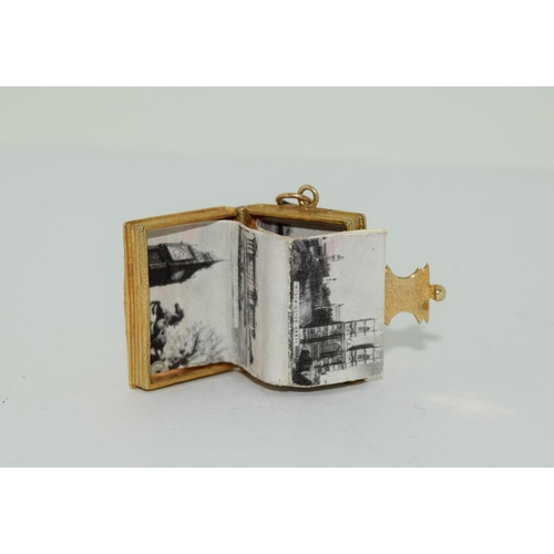 96 - 9ct gold charm depicting a book with photos inside total weight 9gm