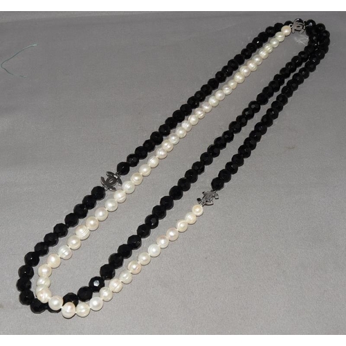 15 - Designer long cultured pearl/onyx silver logo necklace.