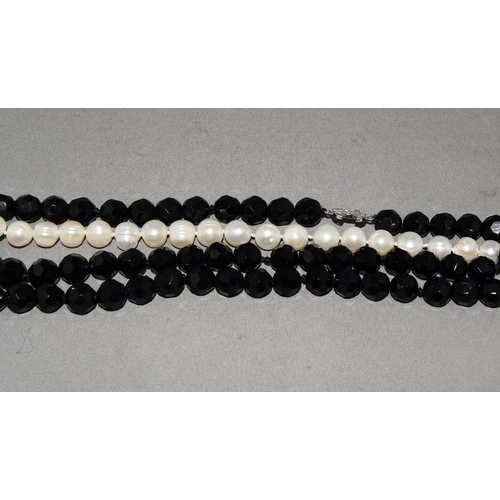 15 - Designer long cultured pearl/onyx silver logo necklace.