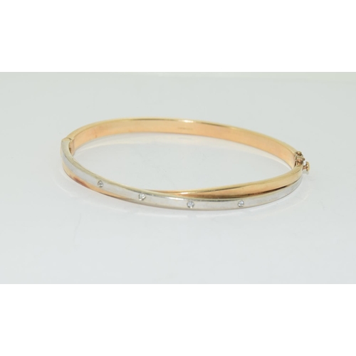 509 - 9ct twin colour ladies diamond set bangle