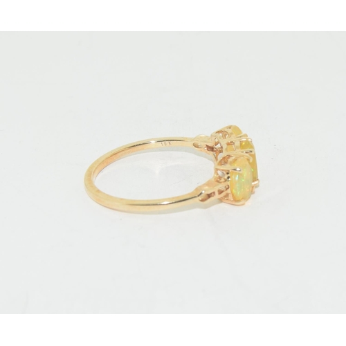 581 - Fire Opal three stone 9ct gold ring Size S