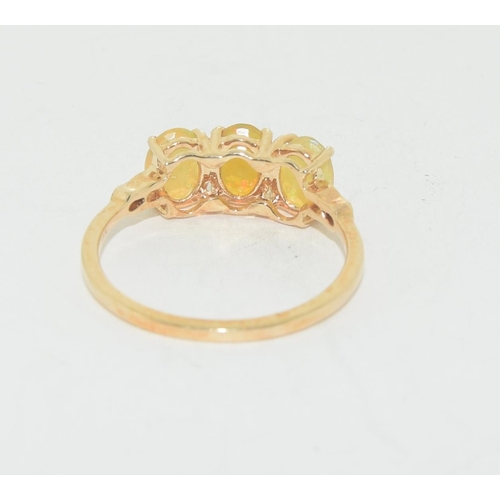 581 - Fire Opal three stone 9ct gold ring Size S