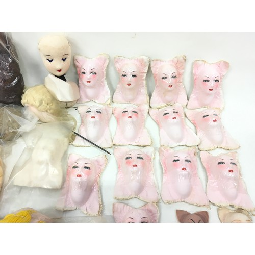 325 - 23 mixed doll faces together with quantity of dolls hair