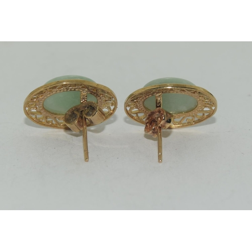 595 - A pair of large natural Jade & 9ct gold earrings.