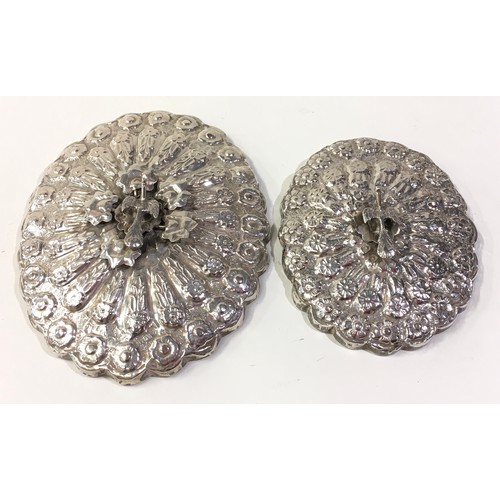 398 - Pair of silver embossed hand mirrors with bird finial decoration