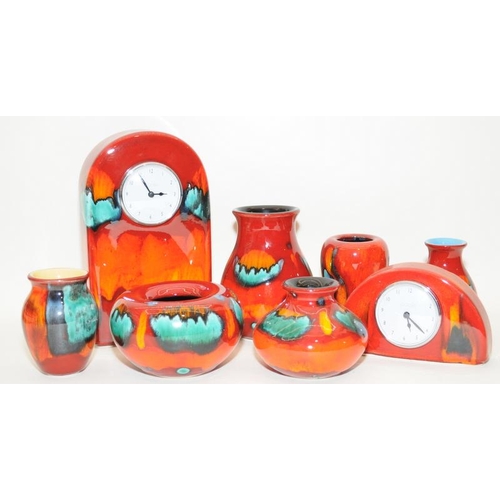 245 - Poole Pottery Volcano to include two clocks, small concave bowl & four vases, together with a small ... 