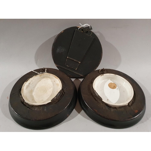 176 - A pair of Victorian ceramic pot lids in oak frames together with another fabric pot lid.