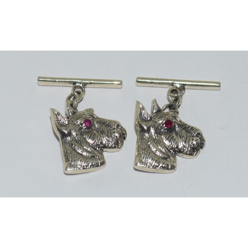 425 - A Pair of silver dog head cuff links set with Ruby eyes.