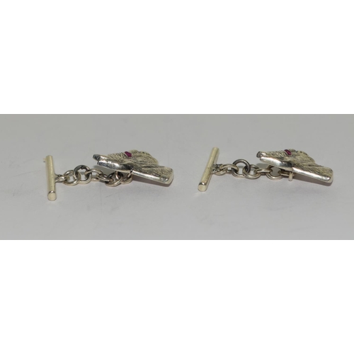 425 - A Pair of silver dog head cuff links set with Ruby eyes.