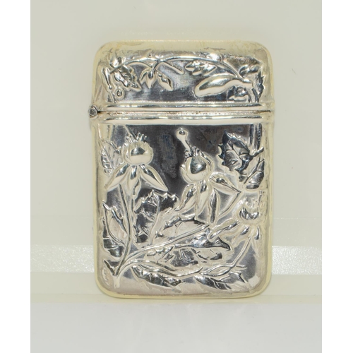 423 - A Silver Vesta case with embossed decoration.