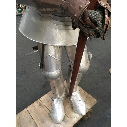 34 - A large life size figure of a knight in shining armour carrying a sword 160cm tall together with a v... 