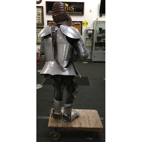 34 - A large life size figure of a knight in shining armour carrying a sword 160cm tall together with a v... 