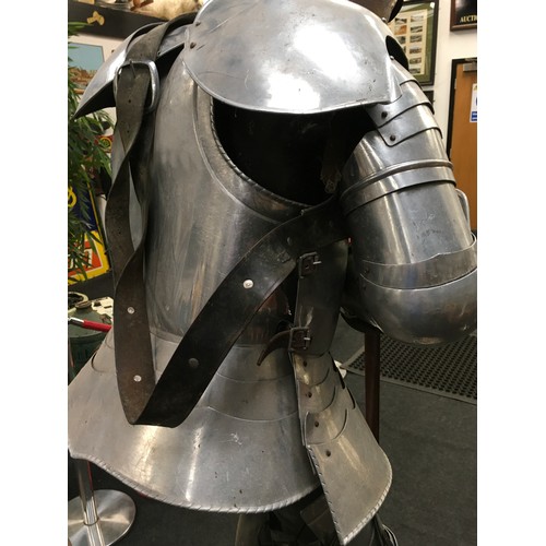 34 - A large life size figure of a knight in shining armour carrying a sword 160cm tall together with a v... 