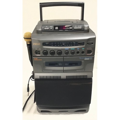 128 - KARAOKE MACHINE. This is made by Arbiter and plays cd and CDG discs. Powers up fine.. comes with 1 m... 